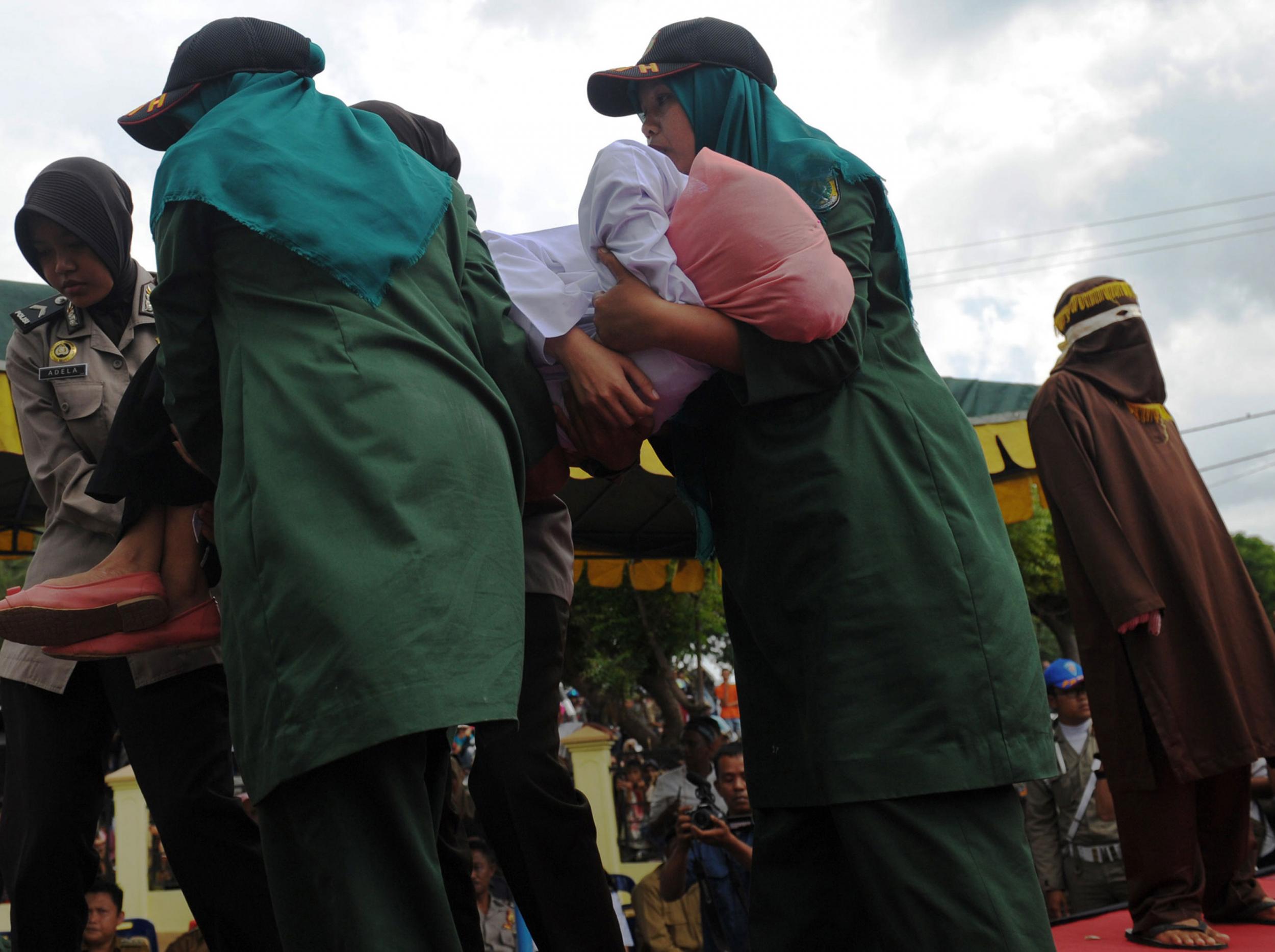 Nur Elita is carried to an ambulance after being struck five times