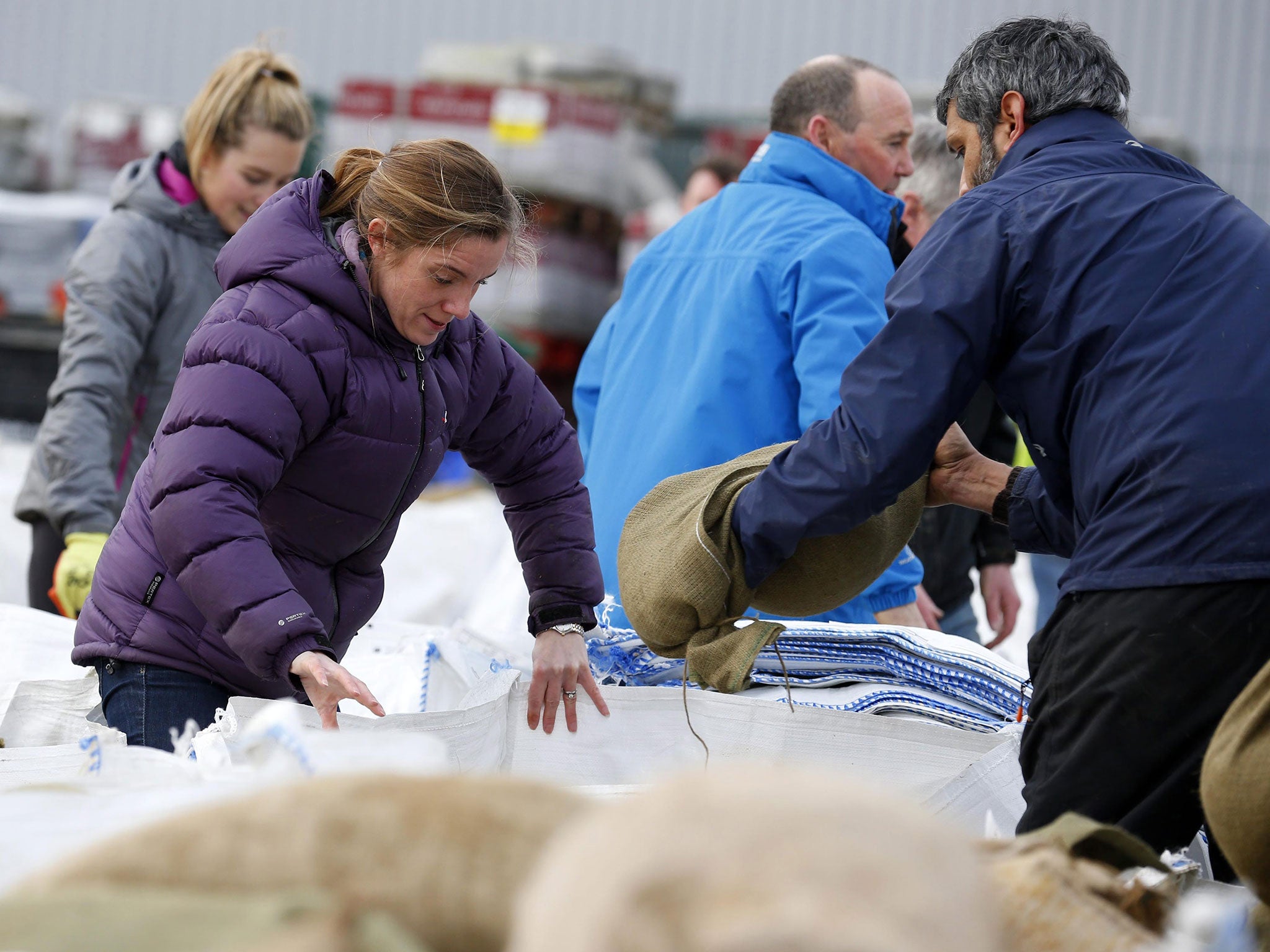 Local volunteers fill sandbags to stem flood water in York city centre on 28 December 2015