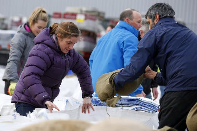 Local volunteers fill sandbags to stem flood water in York city centre on 28 December 2015