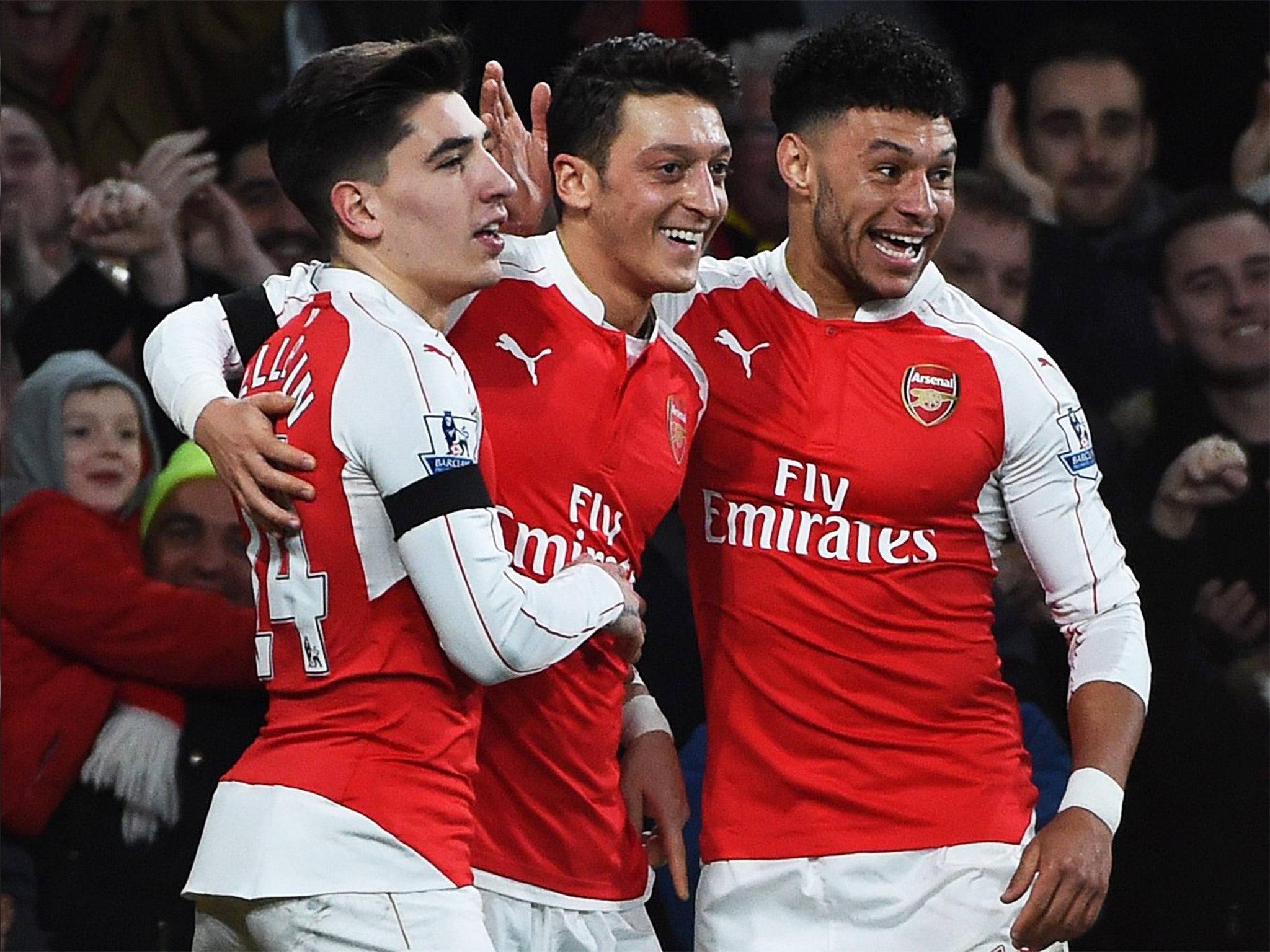 Mesut Özil is congratulated by Hector Bellerin and Alex Oxlade-Chamberlain after scoring against Bournemouth