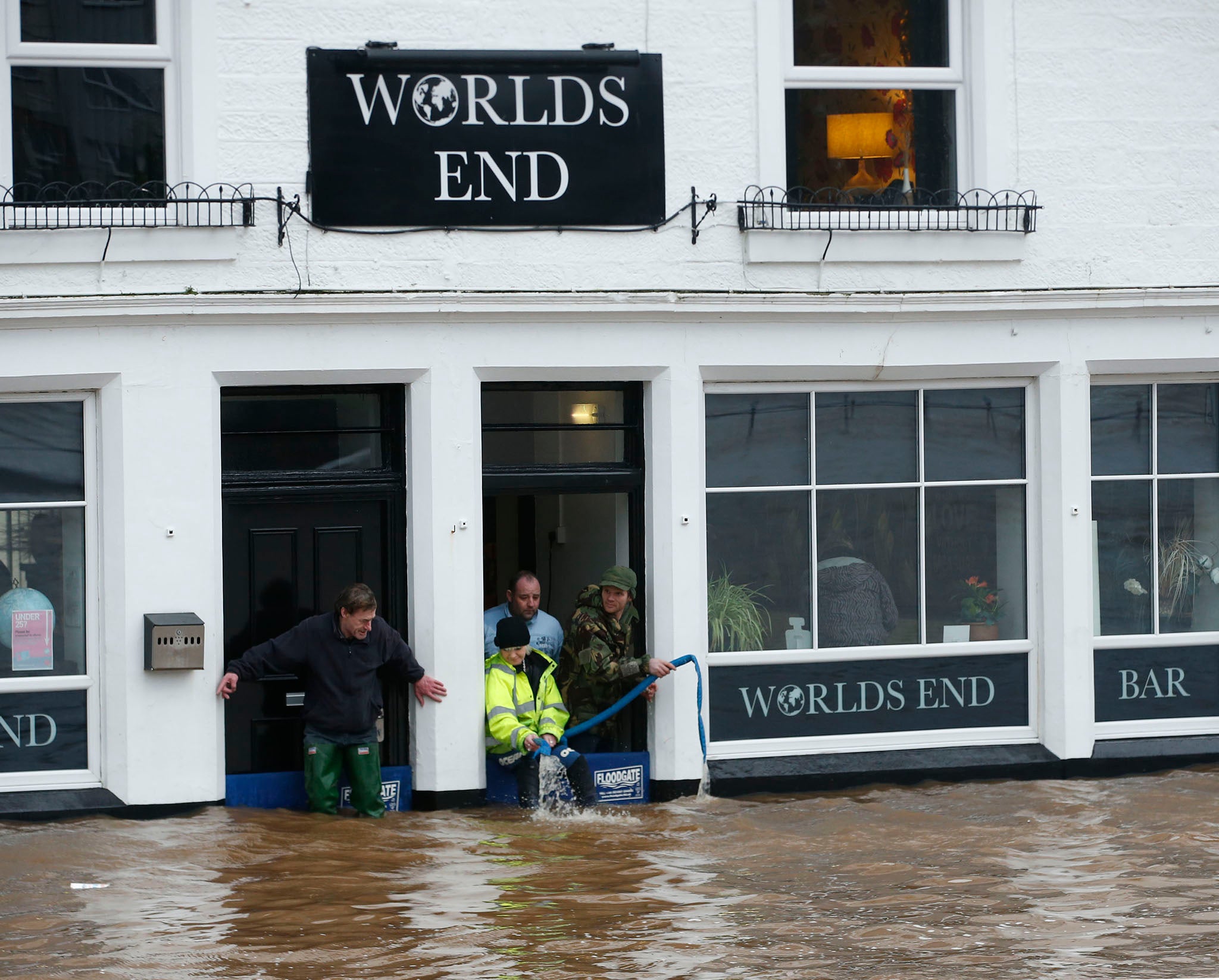 &#13;
Staff at the Worlds End bar in Dumfries Scotland desperately try to pump floodwater out of the building&#13;