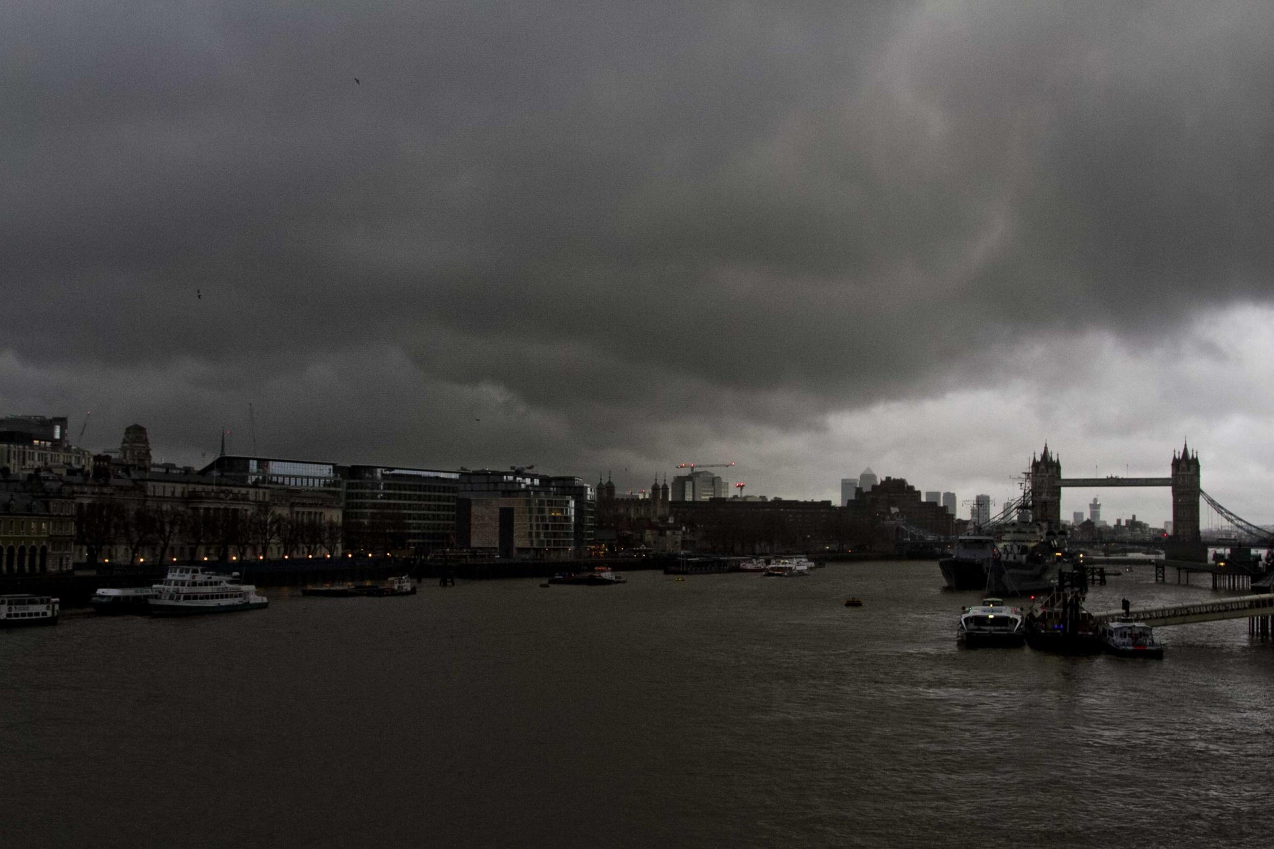 Dark clouds gather over Canary Wharf and Tower Bridge