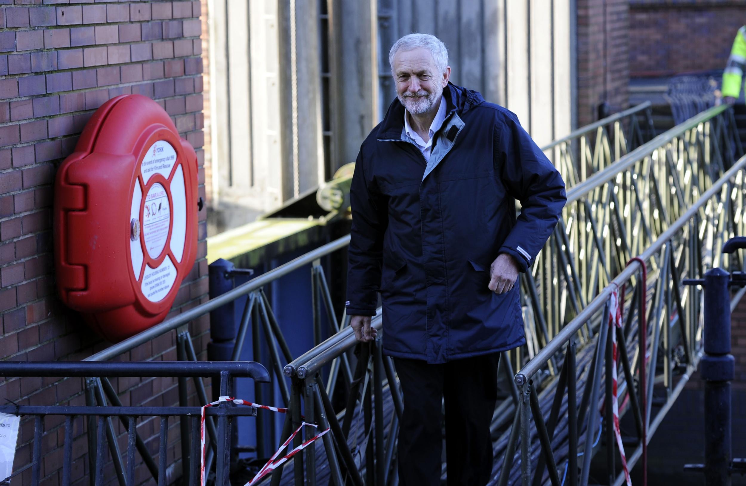 Jeremy Corbyn walks across a foot bridge at the Foss Barrier, during his visit to view flood affected areas in York