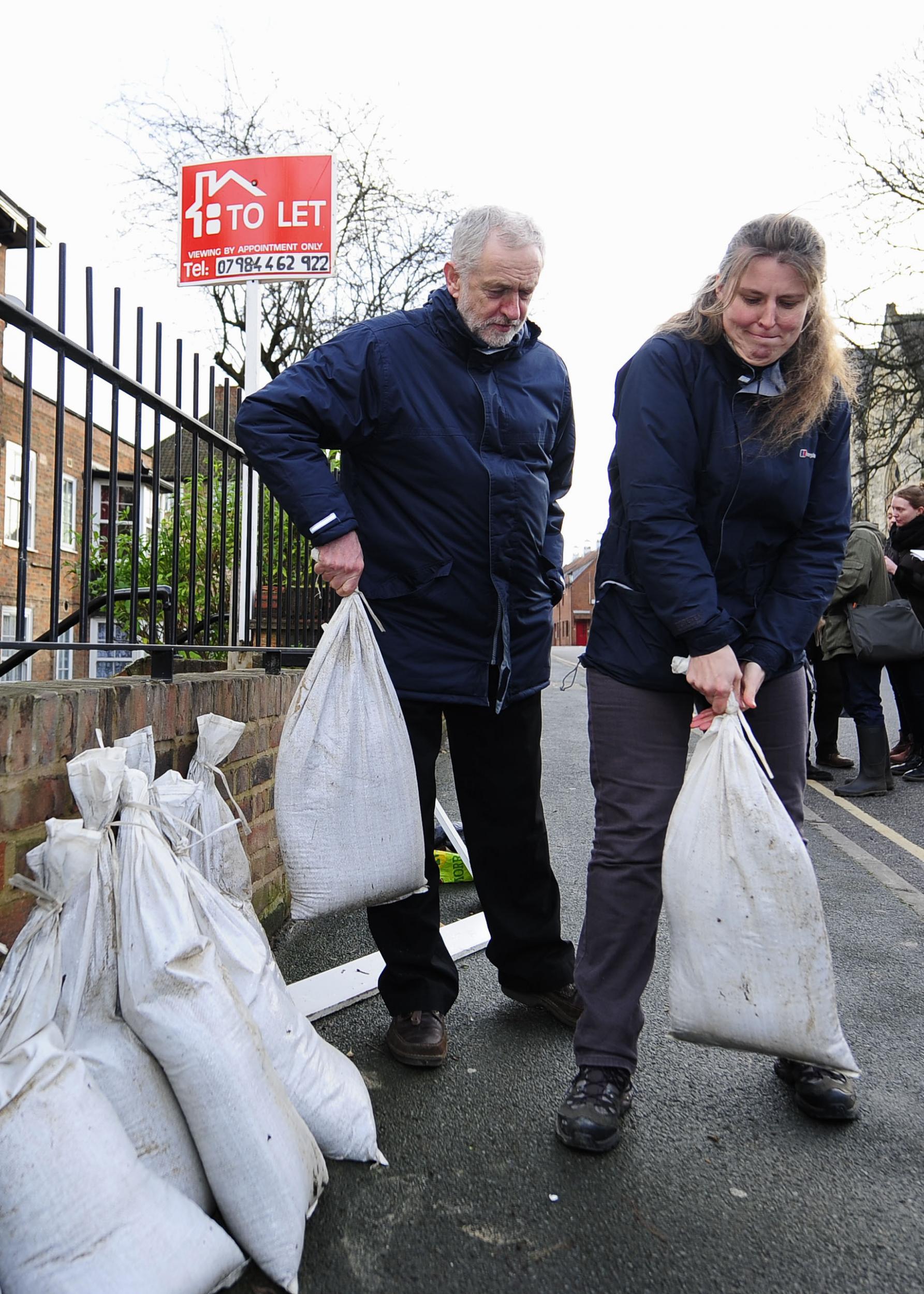 Jeremy Corbyn decided against the traditional footwear of wellies that are usually worn by politicians visiting flood-hit areas and instead wore his brown leather loafers