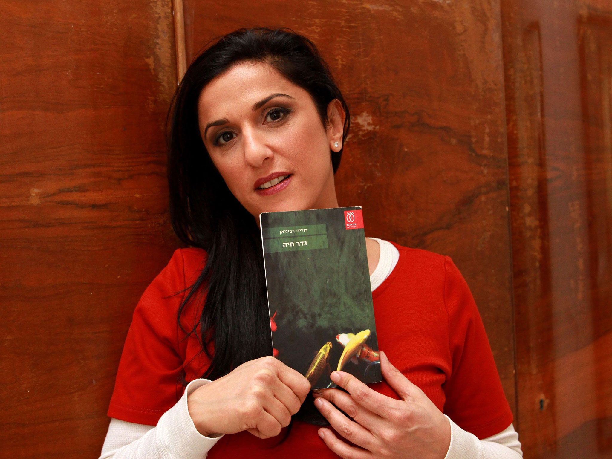 Dorit Rabinyan with her book ‘Borderlife’, which was added to the curriculum before the government stepped in