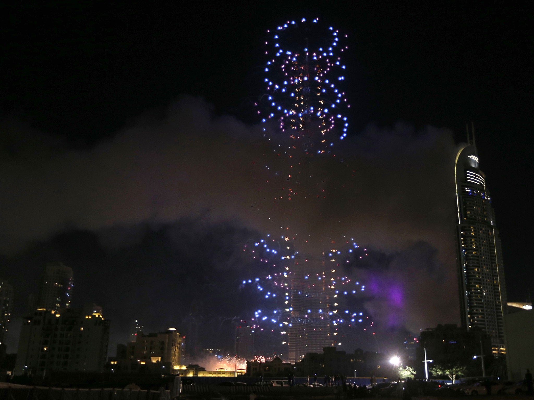 Fireworks explode over Dubai's Burj Khalifa, the world's tallest tower, close to where a huge fire in a luxury hotel injured more than a dozen people hours earlier