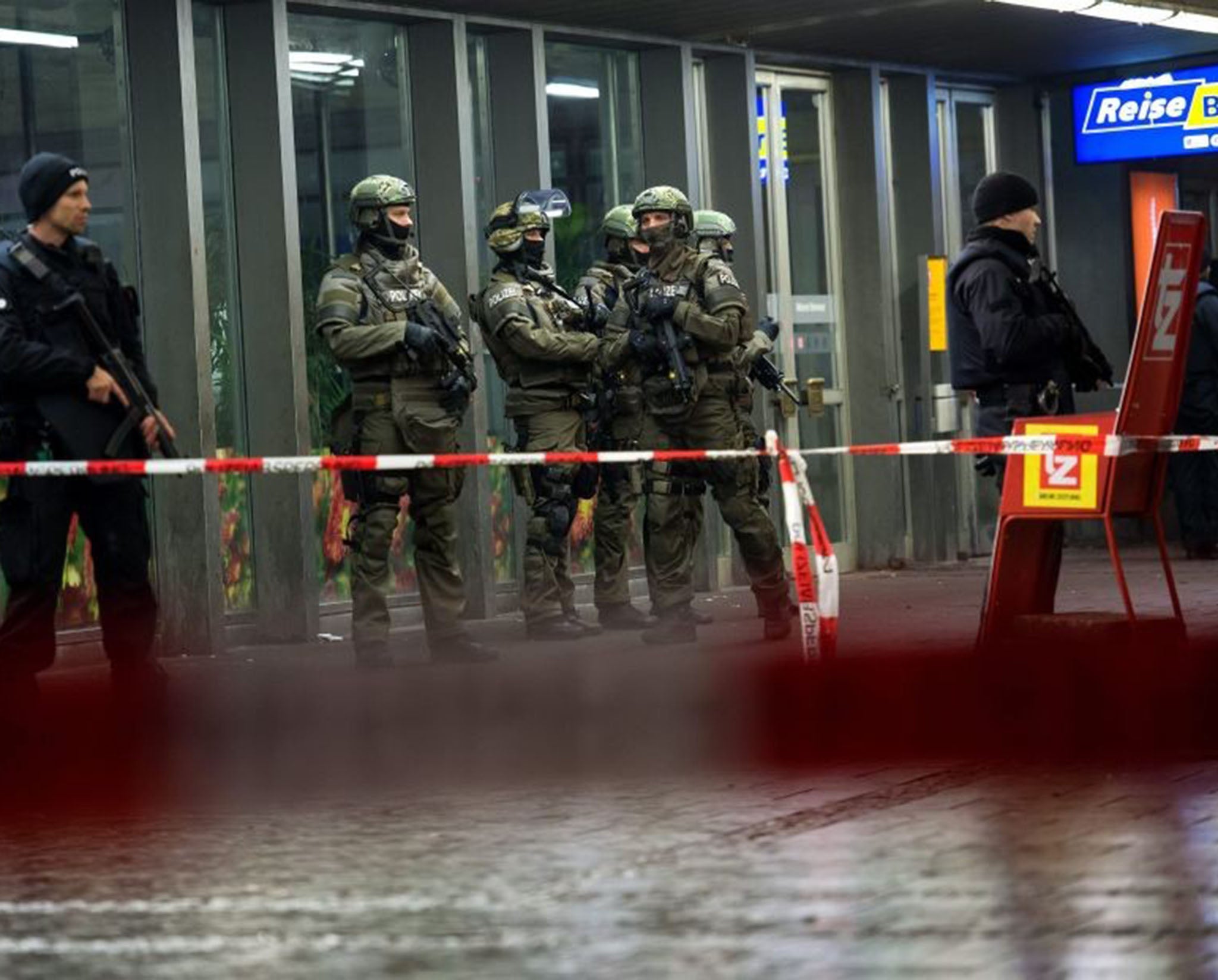 Armed police stand guard outside the evacuated railway station in Munich, Germany after reports of a 'serious' terror threat on New Year's Eve