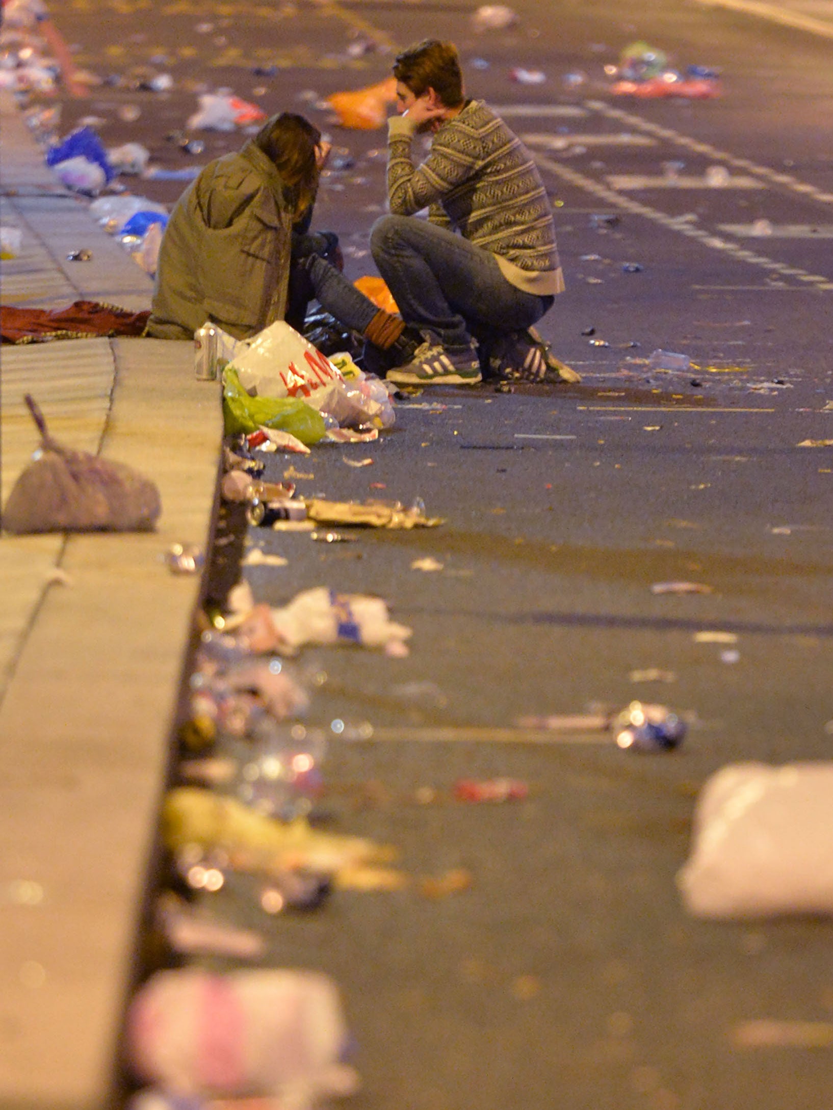 Revellers head home as the clean-up begins in central London after the New Year celebration fireworks