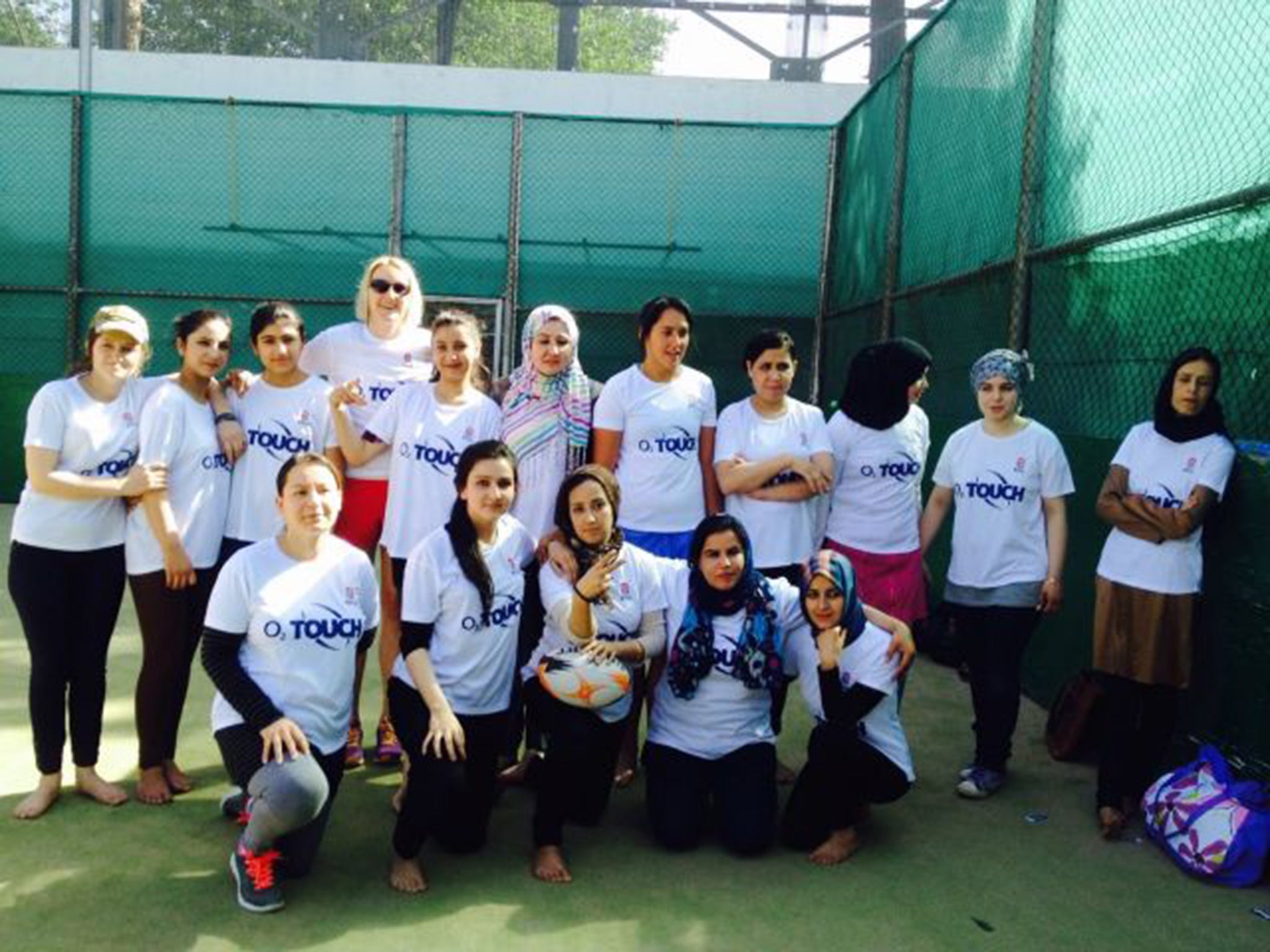 The squad play barefoot on the tennis court of the British embassy in Kabul