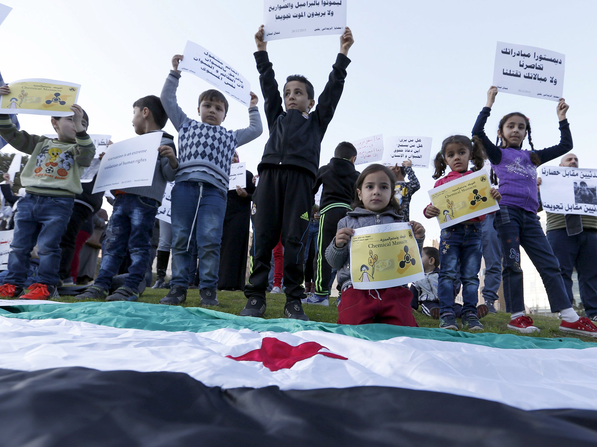 Children carry placards demanding that the siege of Madaya and Zabadani in Syria is lifted, in front of the offices of the UN headquarters in Beirut, Lebanon