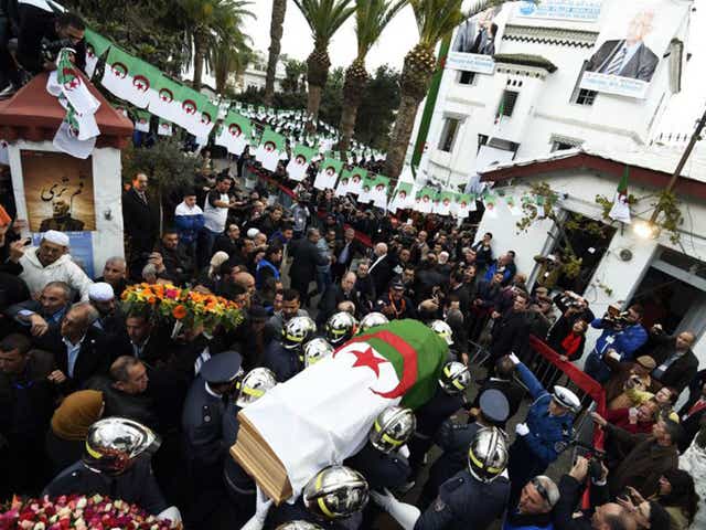 Firemen carry the coffin of opposition leader Hocine Aït Ahmed in Algiers