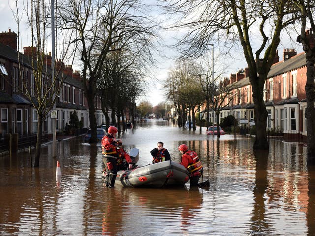 The emergency services prepare to rescue residents from a flooded street in Carlisle
