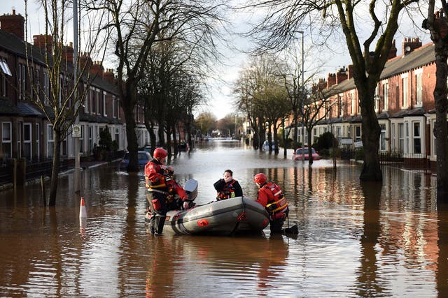 The emergency services prepare to rescue residents from a flooded street in Carlisle