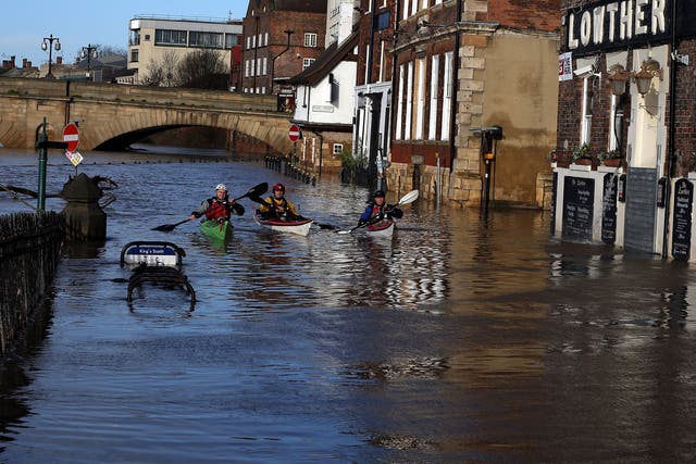 Canoeists check out buildings in flooded York