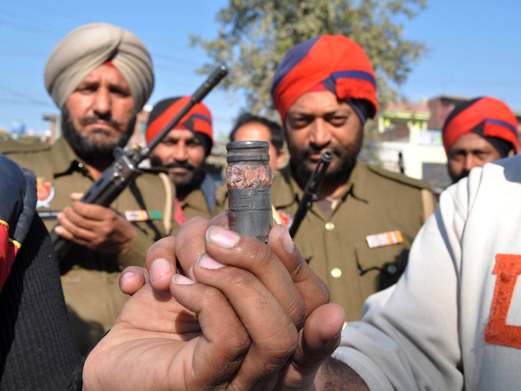 Indian police show what is said to be ammunition found after the raid