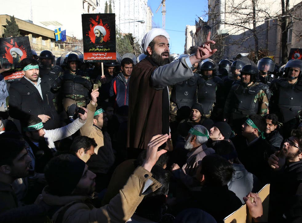 A Muslim cleric addresses a crowd during a demonstration to denounce the execution of Saudi Shiite Sheikh Nimr al-Nimr