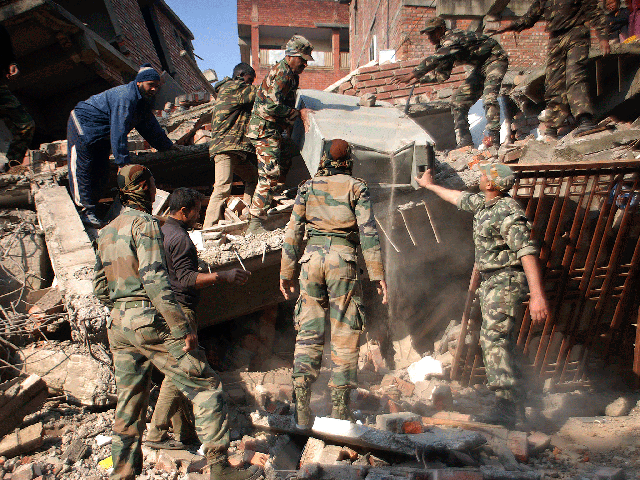 Indian soldiers remove debris from a damaged building after an earthquake in Imphal, capital of the northeastern Indian state of Manipur, Monday, Jan. 4, 2016.