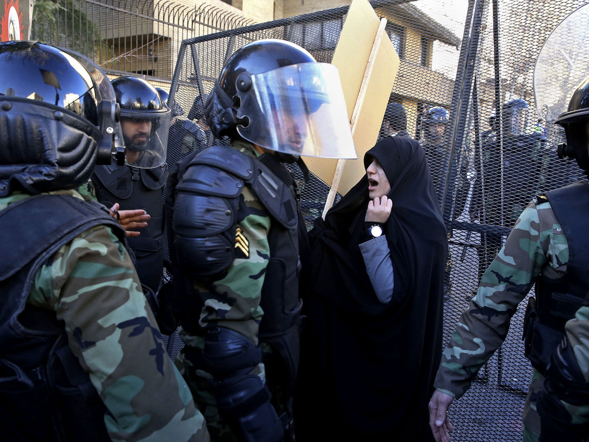 Police officers try to disperse protesters in front of the Saudi Embassy in Tehran, Iran, Sunday, Jan. 3, 2016