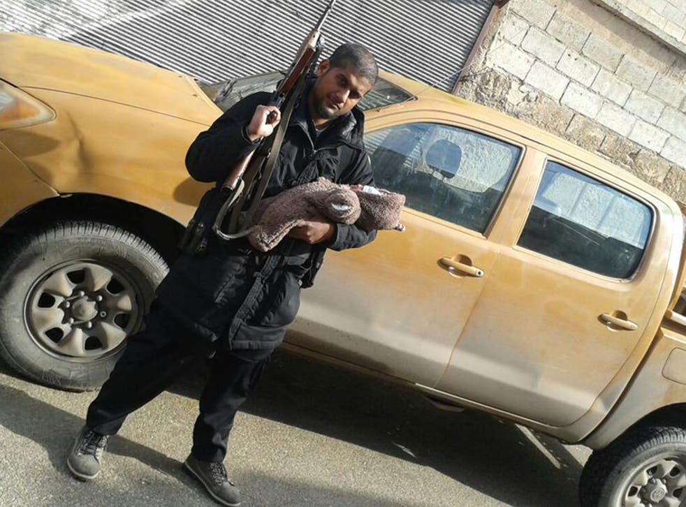 Ex-bouncy castle salesman Siddhartha Dhar pictured here in Syria with his newborn son