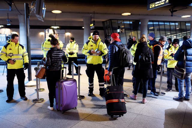 Security staff check passengers’ documents at Kastrups railway station outside Copenhagen. Some 17,000 commuters cross between Malmo in Sweden and the Danish capital every day