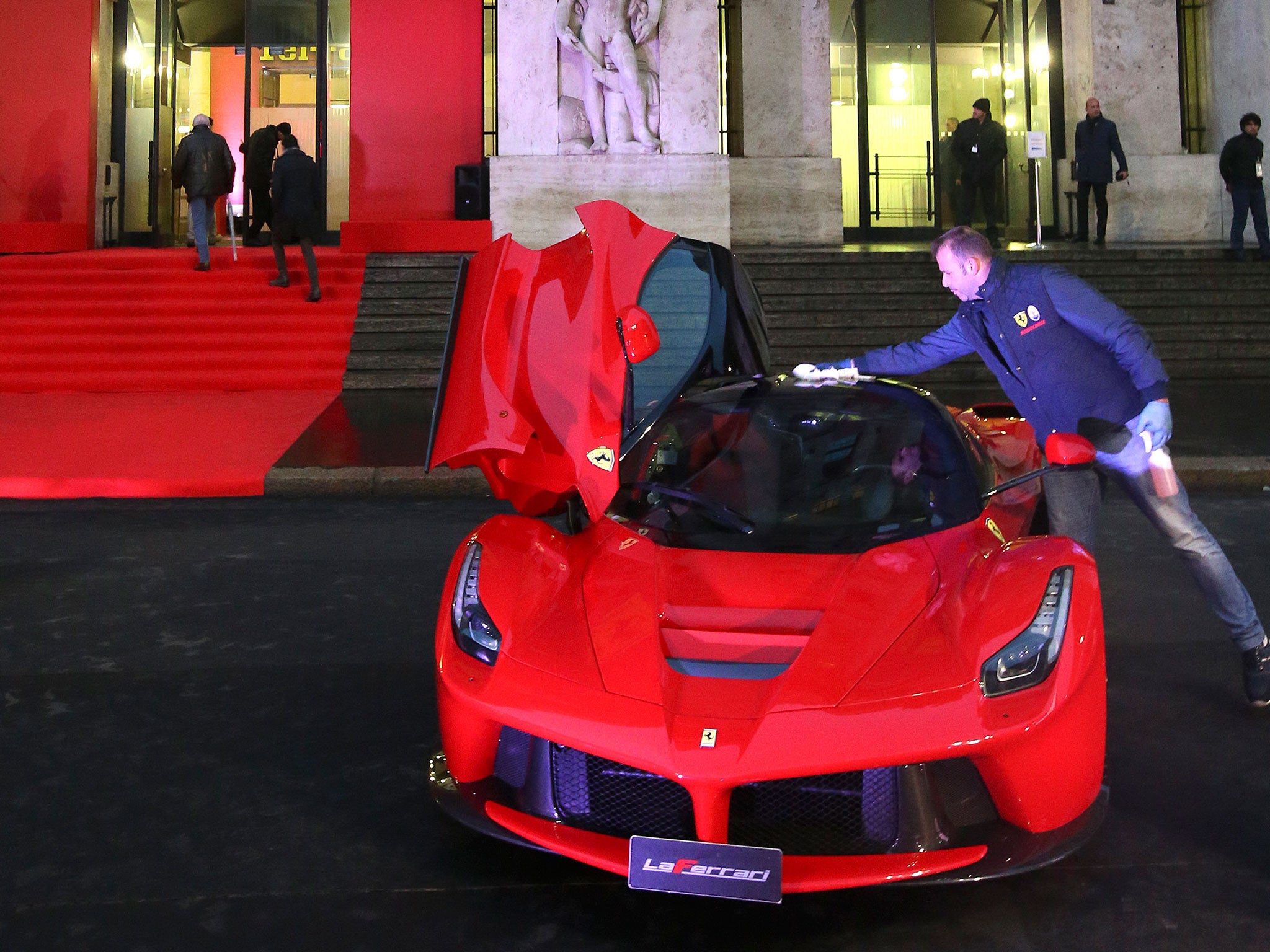 The famous red and yellow of Ferrari dominates the front of Milan’s stock exchange