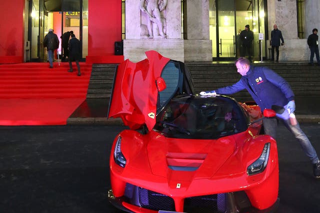 The famous red and yellow of Ferrari dominates the front of Milan’s stock exchange