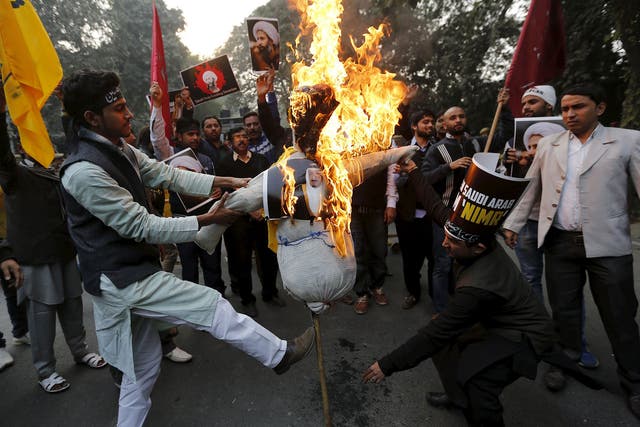Protesters burn an effigy of Saudi King Salman bin Abdulaziz outside the Saudi embassy in India