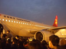 Woman ‘tries to open plane door mid-flight in suicide bid’