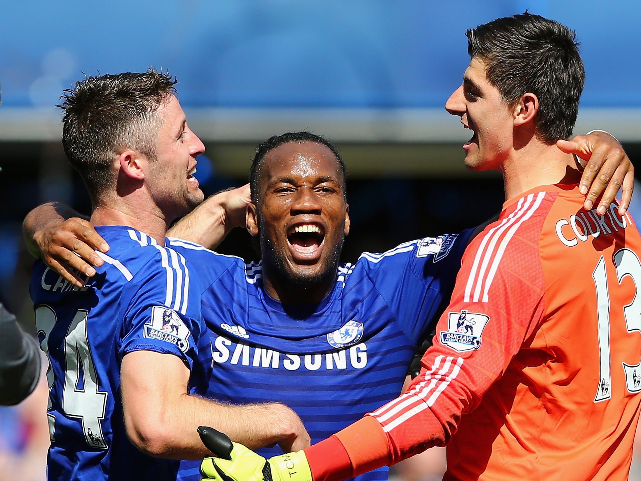 Dider Drogba celebrates Chelsea's title win last season with Thibaut Courtois (right) and Gary Cahill (left)