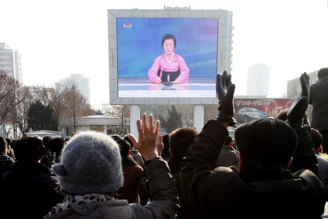 North Koreans watch a news broadcast announcing the reported weapons test in Pyongyang