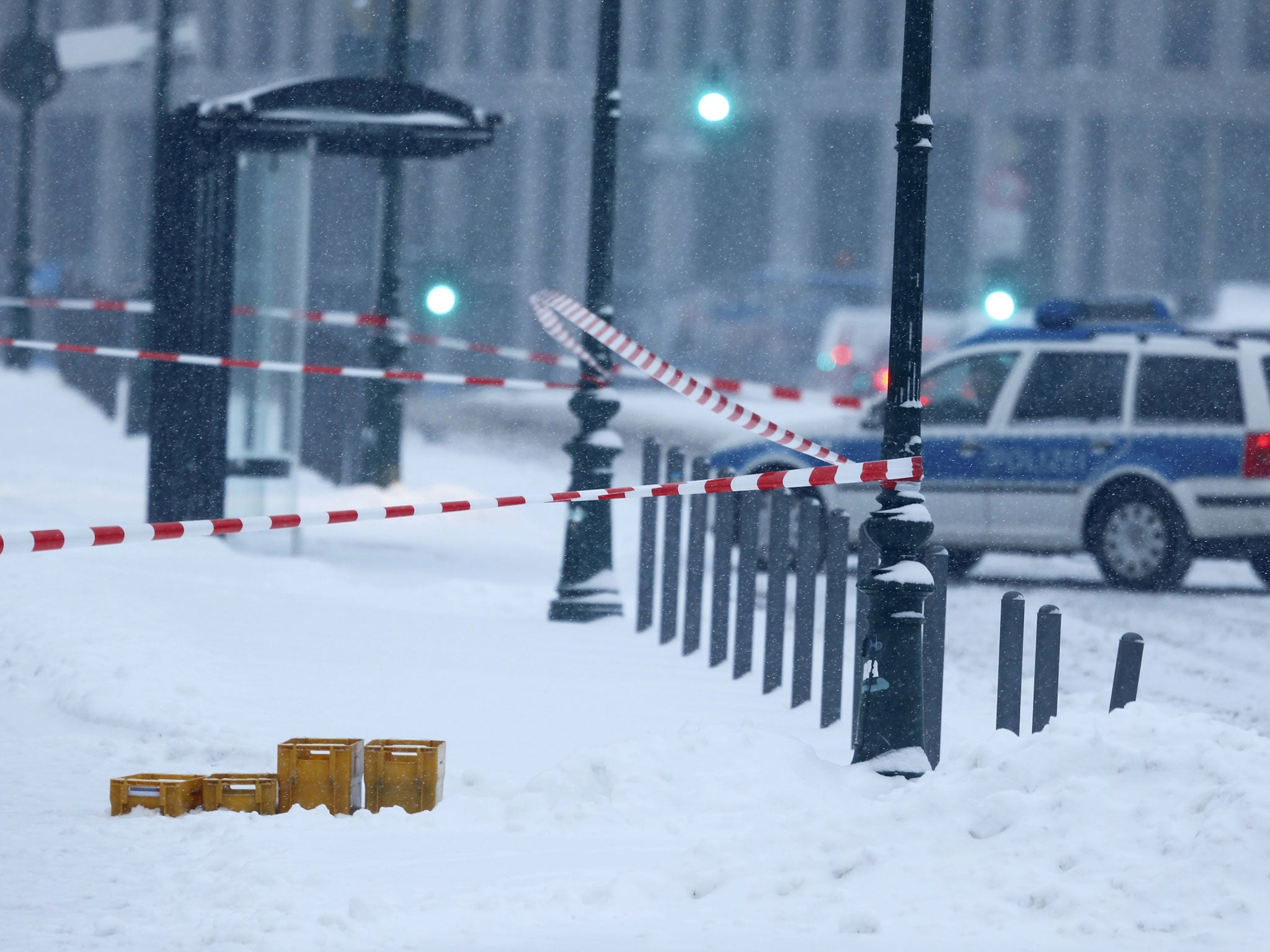 An image from the scene showed four yellow postal crates abandoned in heavy snow outside the chancellory in Berlin