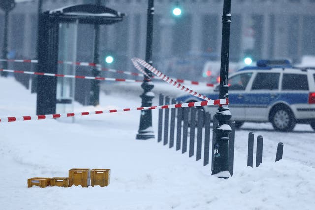 An image from the scene showed four yellow postal crates abandoned in heavy snow outside the chancellory in Berlin