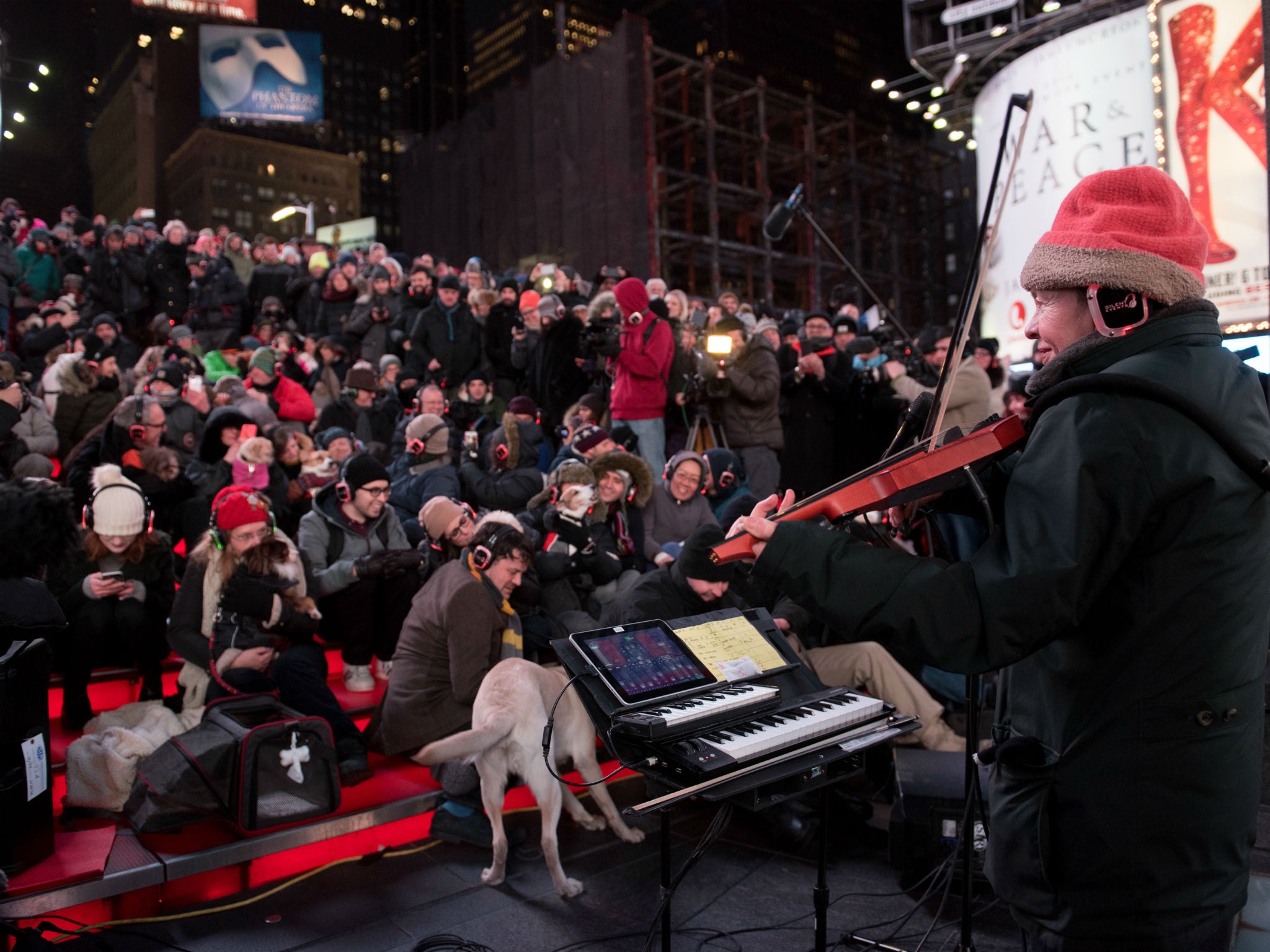 Laurie Anderson plays music at a low-decibel level for dogs in Times Square