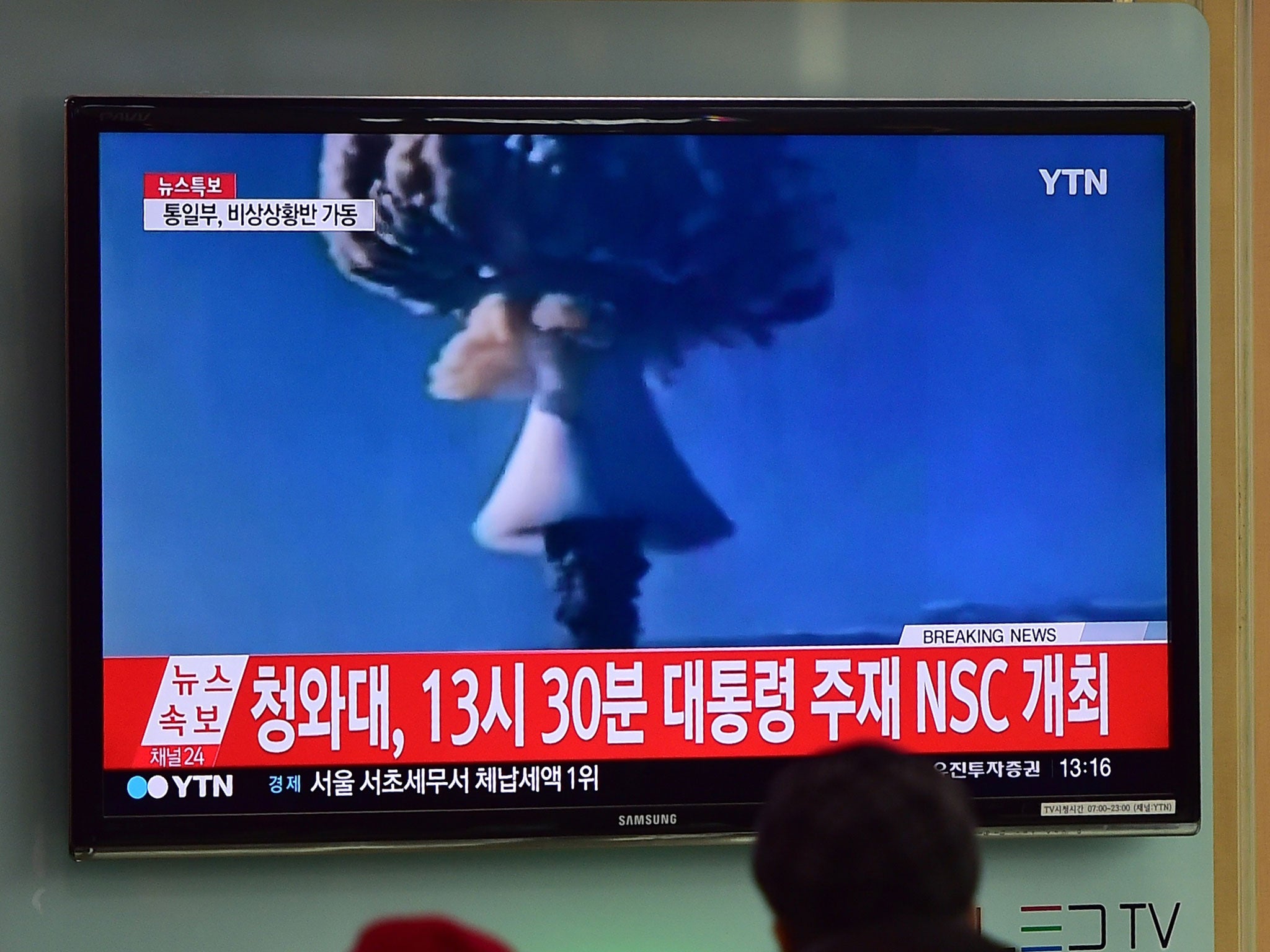 People watch a news report on North Korea's first hydrogen bomb test at a railway station in Seoul