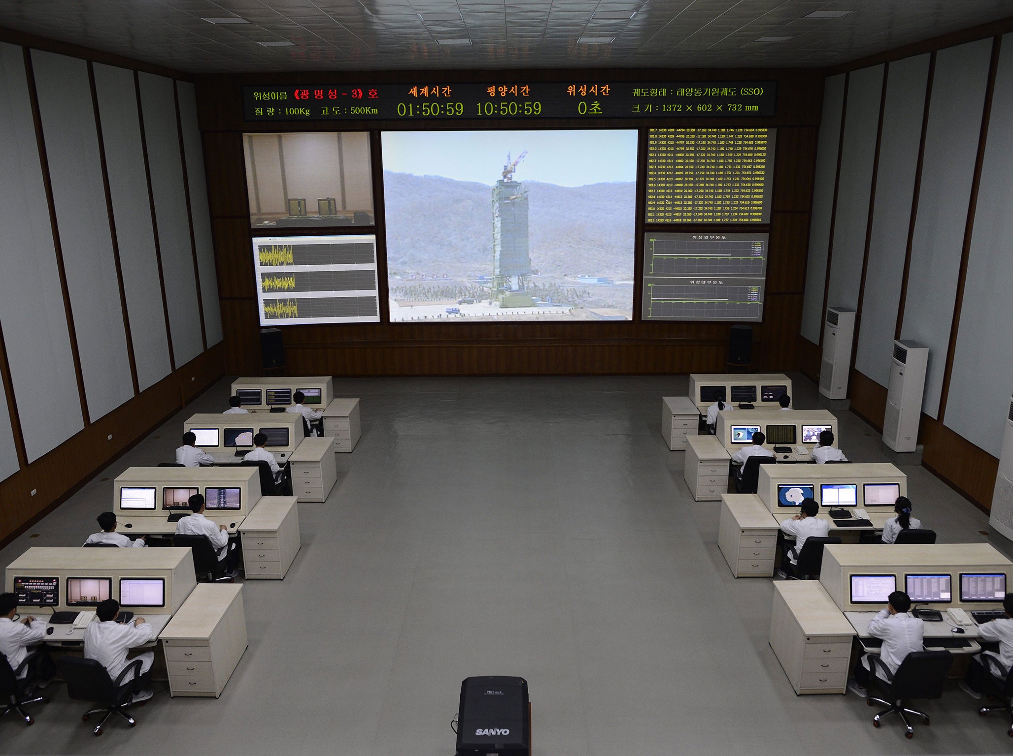 North Korea technicians watch live images of the rocket Unah-3 at the satellite control room of the space center on the outskirts of Pyongyang on April 11, 2012