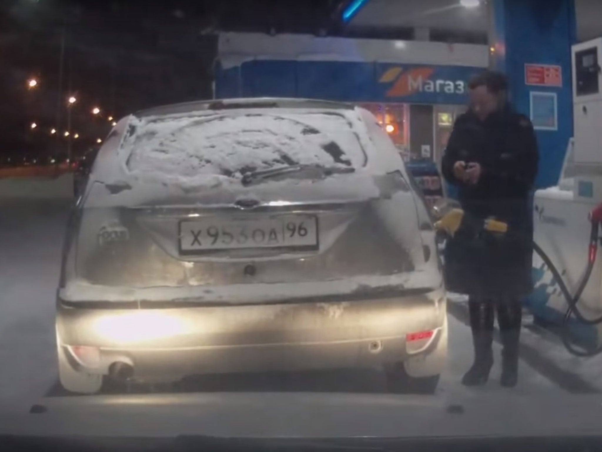 The footage begins as the woman fills up her petrol tank at the Russian forecourt