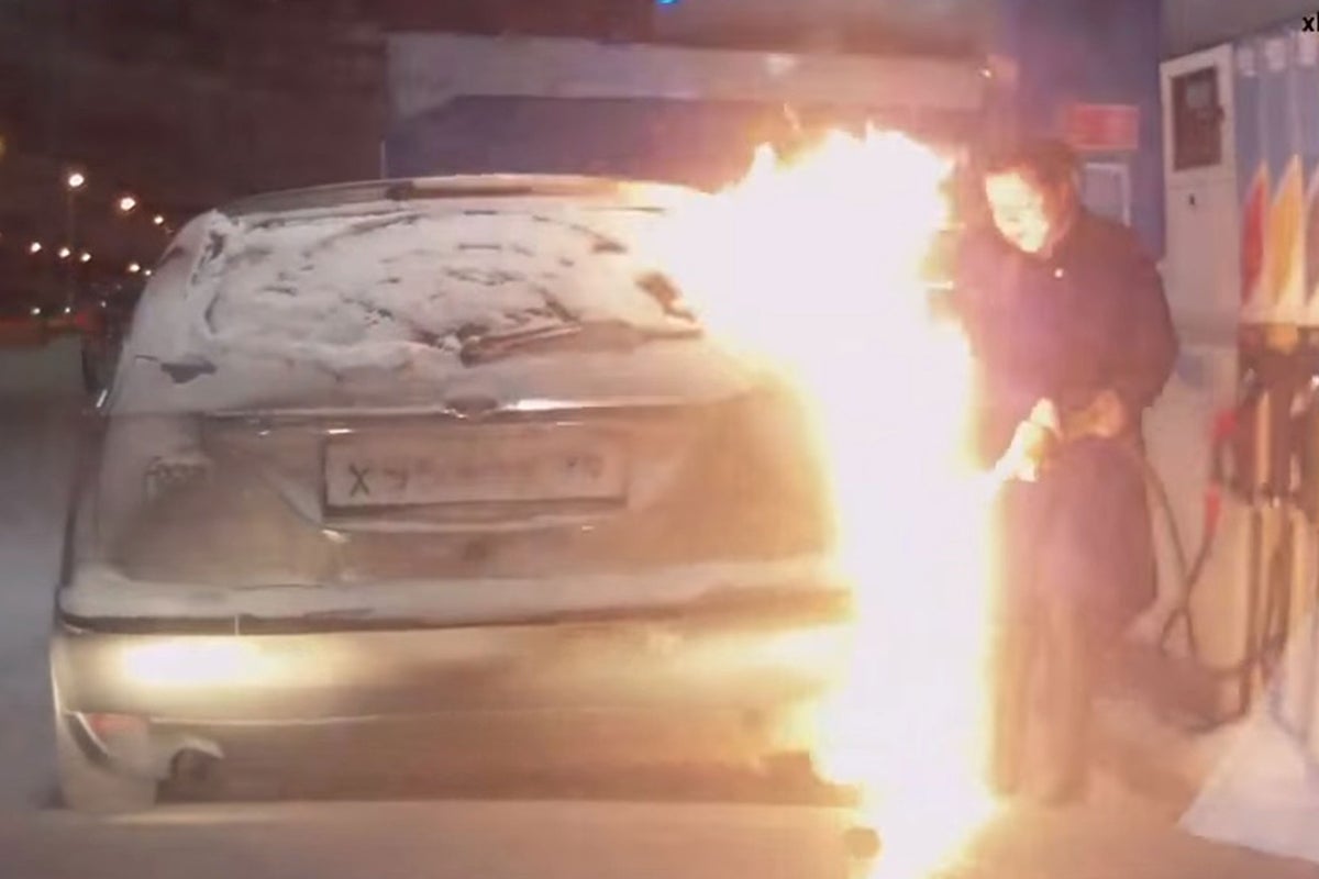 Woman sets car on fire at petrol station after using a lighter to peer ...
