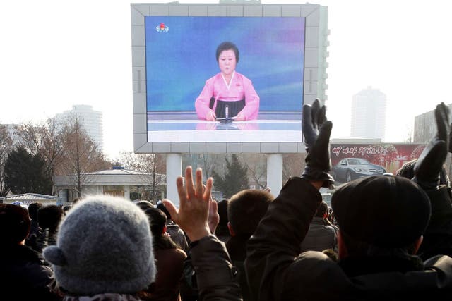 North Koreans watch a news broadcast on a video screen outside Pyongyang Railway Station in Pyongyang, North Korea, Wednesday, Jan. 6, 2016.
