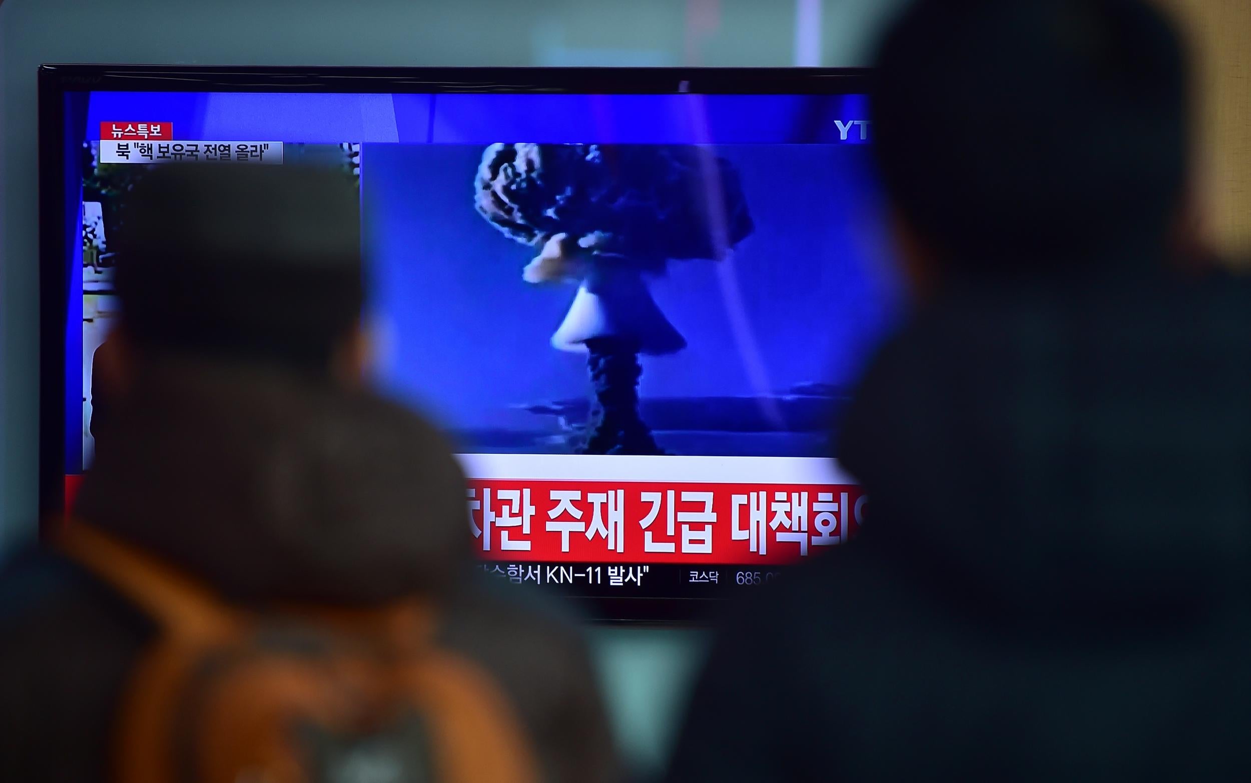 South Koreans watch a news report on North Korea's bomb test in a Seoul train station