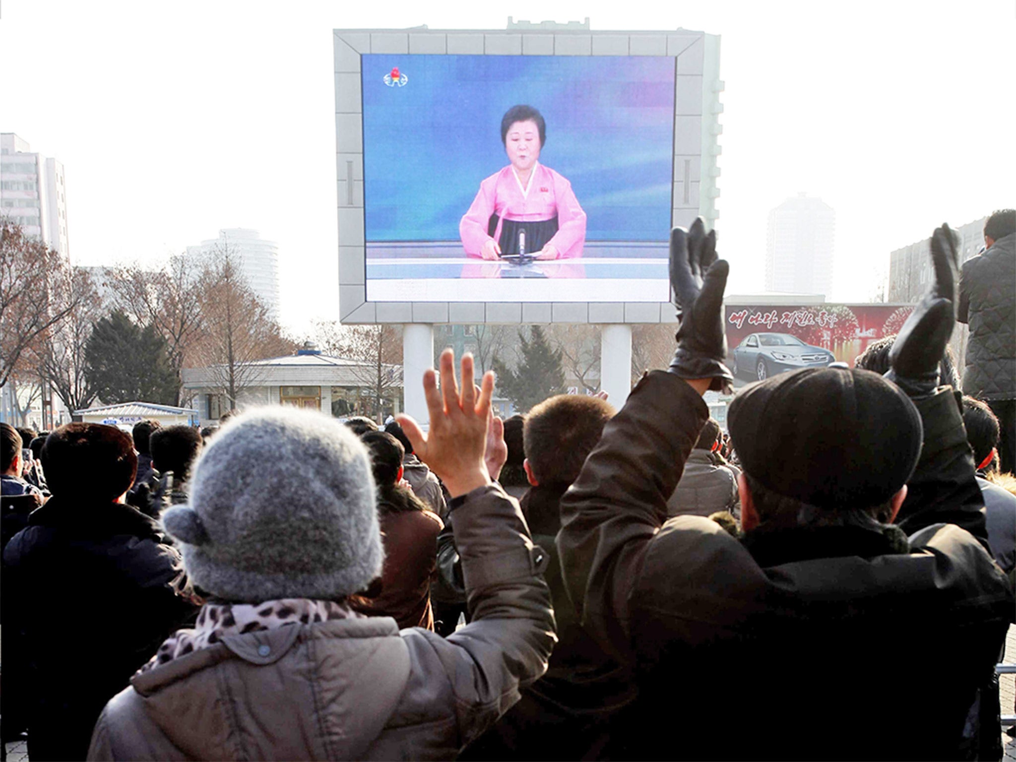 Jubilant North Koreans watch a news broadcast on a video screen outside Pyongyang railway station, in North Korea, announcing the claimed successful hydrogen bomb detonation test