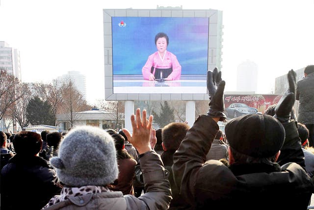 Jubilant North Koreans watch a news broadcast on a video screen outside Pyongyang railway station, in North Korea, announcing the claimed successful hydrogen bomb detonation test
