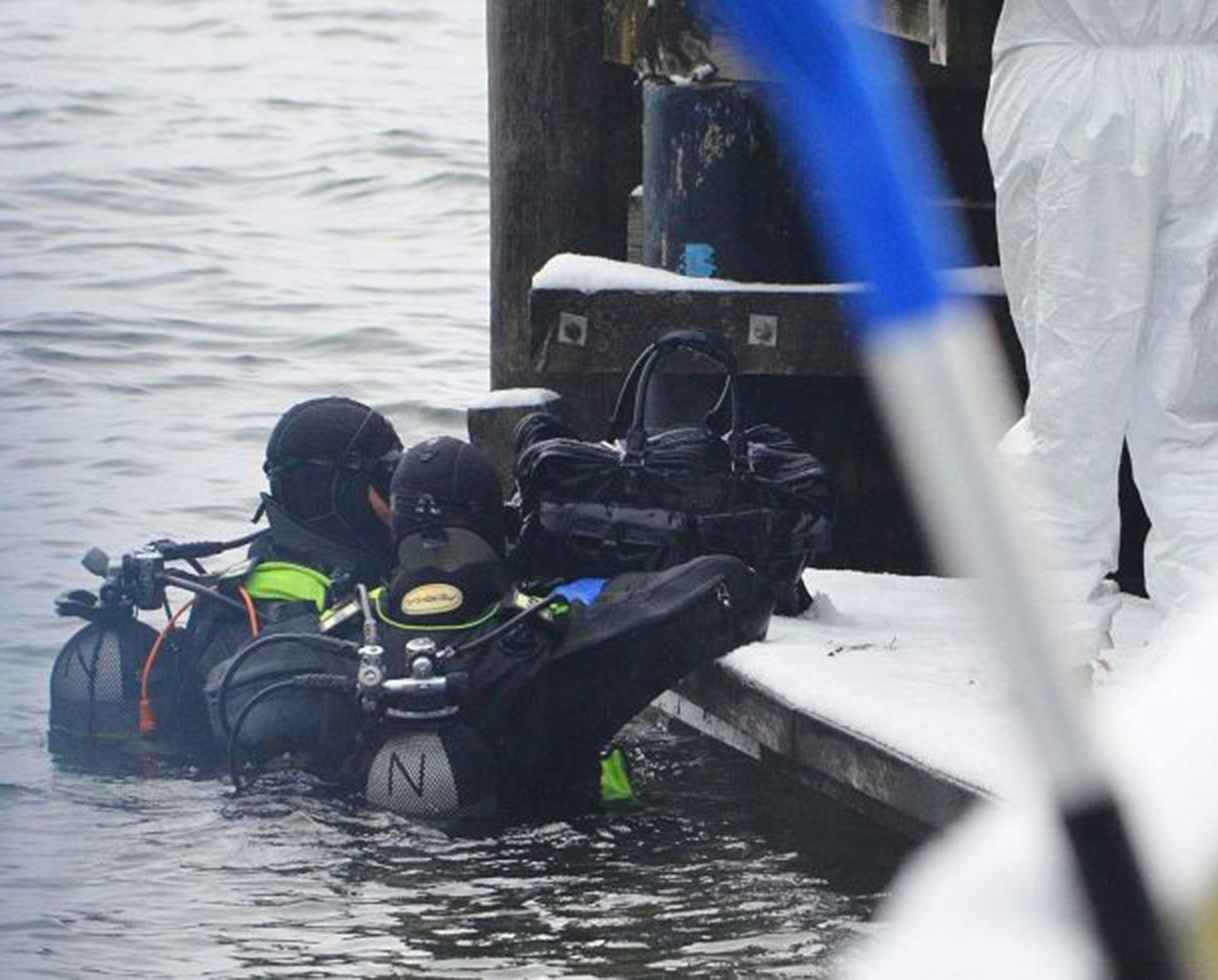 Divers recovering suitcases from the lake in Austria
