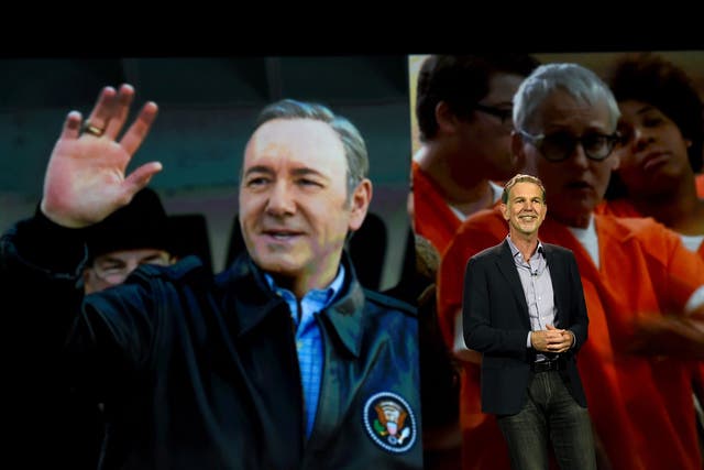 Netflix CEO Reed Hastings delivers a keynote address in front of an image of actor Kevin Spacey from 'House of Cards' and an image from the show 'Orange is the New Black' at CES 2016 at The Venetian Las Vegas on January 6, 2016 in Las Vegas, Nevada