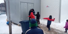 Refugee children defeat Serbian police officer in snowball fight