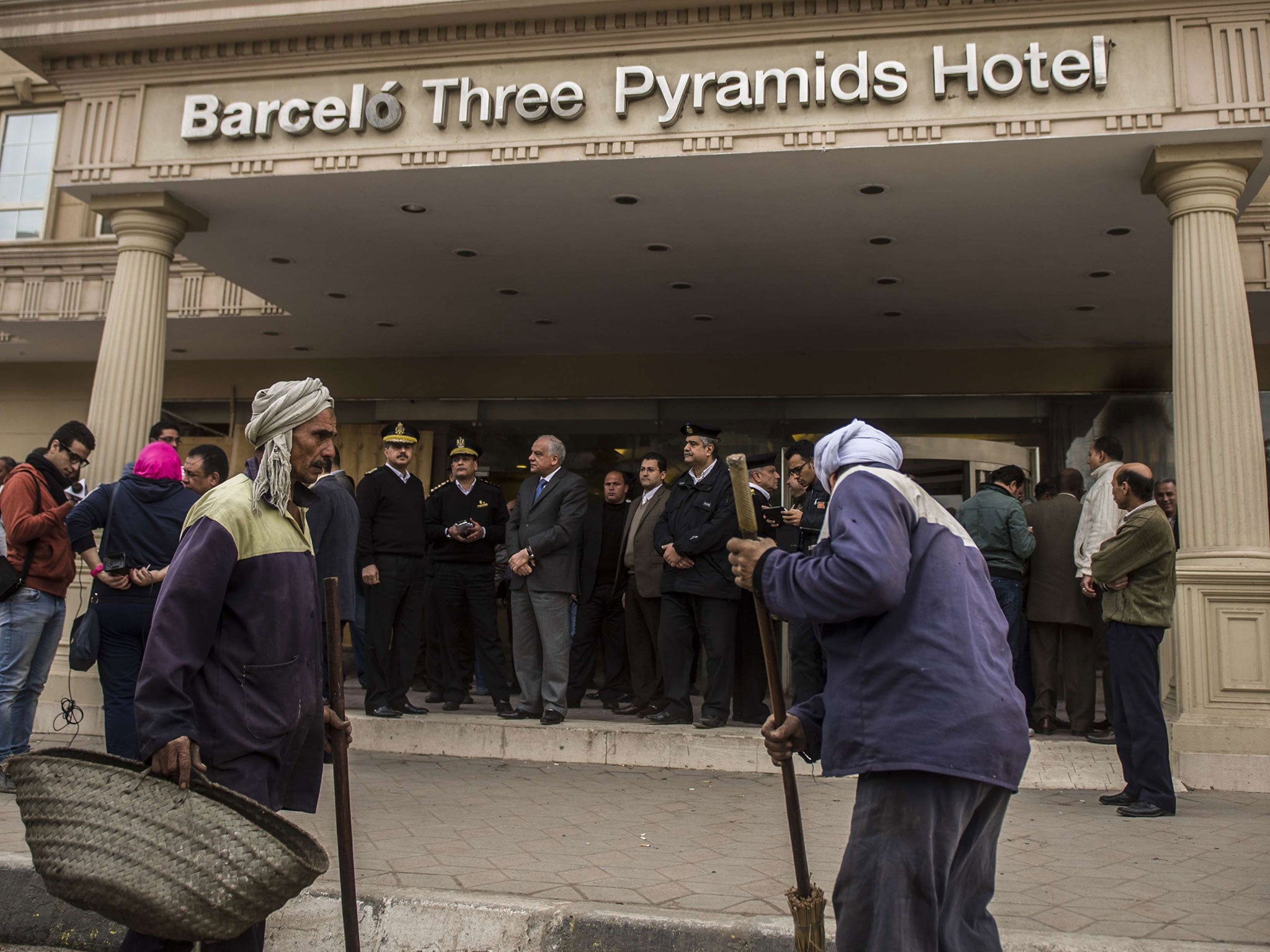Egyptian security forces stand at the entrance of the Three Pyramids hotel in Cairo's al-Harm district on January 7, 2016