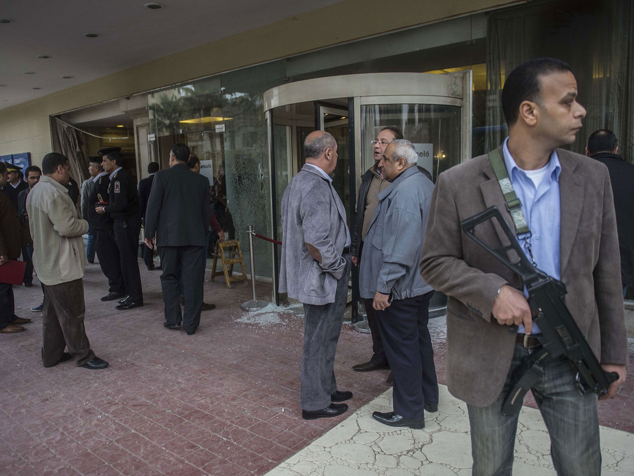 Egyptian security forces stand at the entrance of the Three Pyramids hotel in Cairo's al-Harm district on January 7, 2016