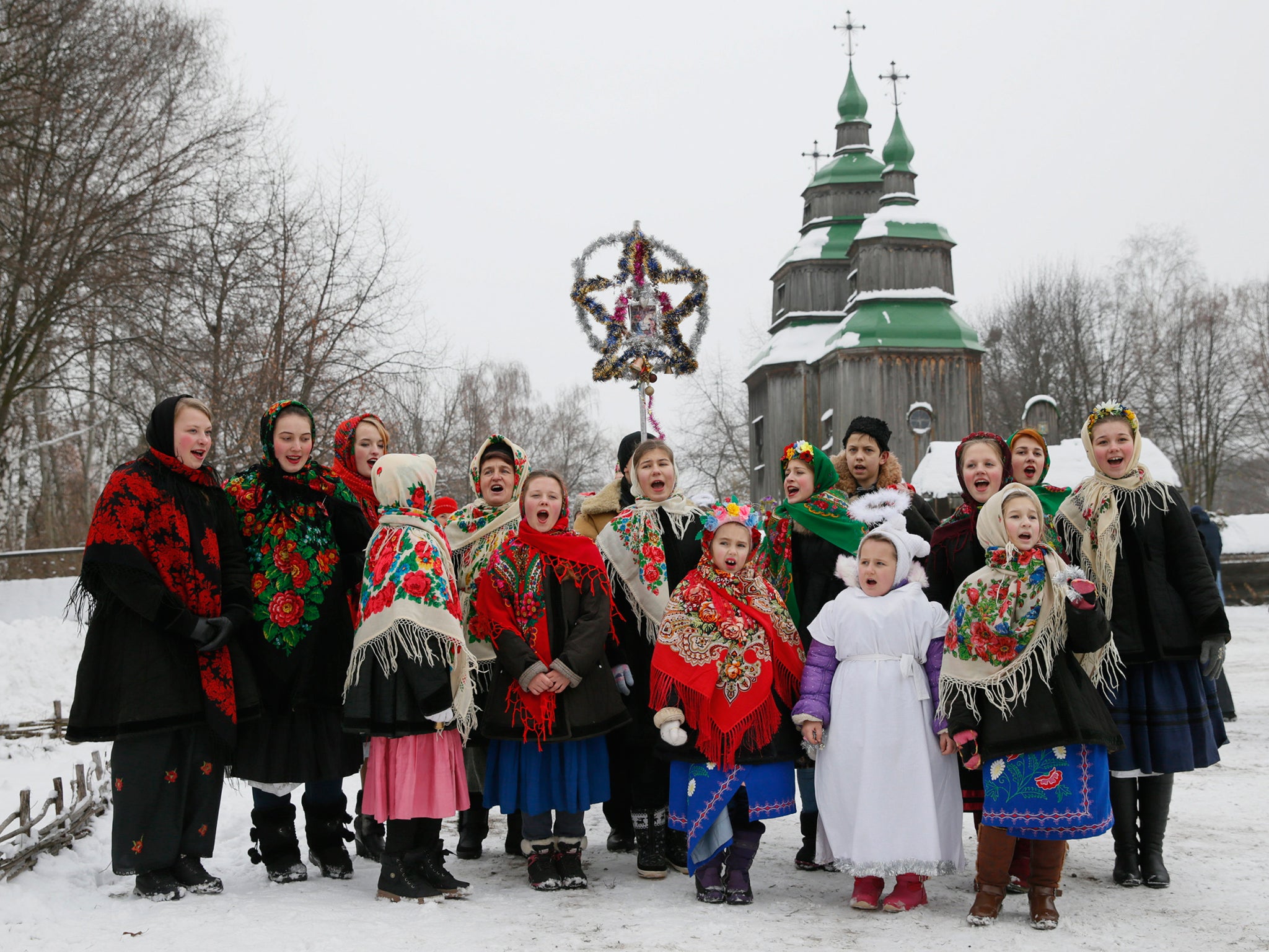 People dressed in traditional costumes sing Christmas carols in Kiev