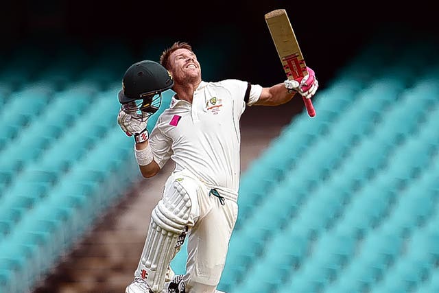 Australia batsman David Warner celebrates reaching his century against West Indies yesterday in front of the SCG’s empty seats afp