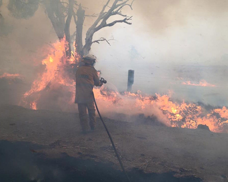 A firefighter works on putting out flames in Yarloop, Western Australia
