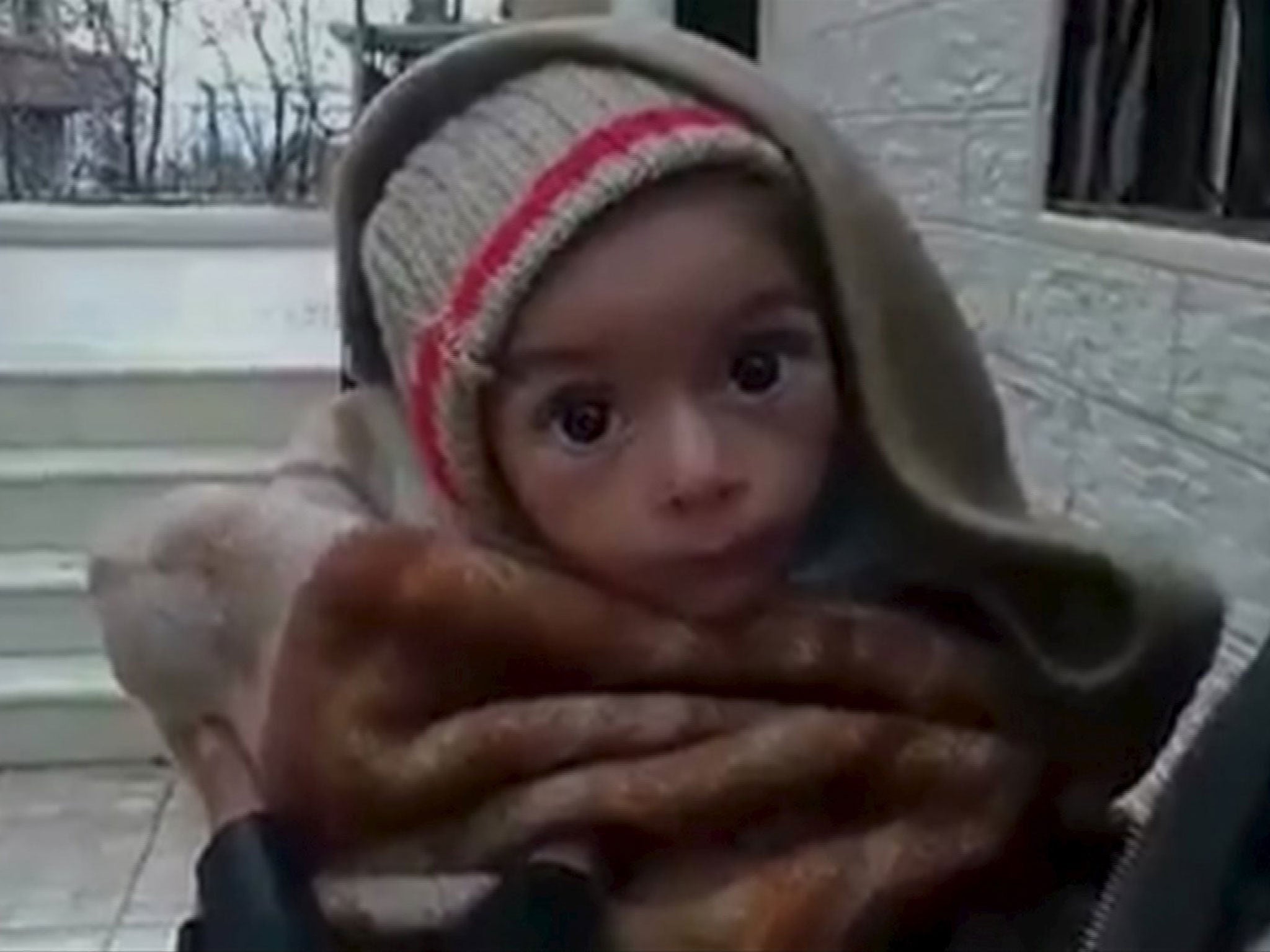 A toddler is held up to the camera in this still image taken from video said to have been shot in Madaya, Syria